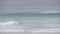 Surfers on sandy ocean beach. People surfing, autumn or winter California waves.