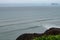 Surfers seen from the Miraflores cliffs, Lima, Peru