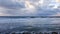 Surfers silhouetted with colourful sky and sea background