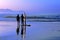 Surfers with sunset reflection on surfboard