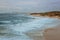 Surfers surf on the waves at Palmahim beach in Israel at sunset