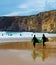 Surfers surfboards beach Portugal cliff