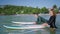 Surfers in swimwear paddling on surfboards. Man, woman in swimsuit swim to lineup lying on board. Couple in love goes to