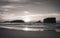 Surfers taking breaking wave on scenic atlantic ocean in black and white, capbreton, france