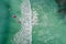 Surfers in tropical ocean waiting wave. Aerial view made with drone