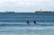 Surfers and Vessel against Blue Cloudy Sky
