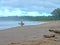 Surfers wait for the perfect wave on the shore holding surfboards