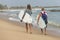 Surfers walking on the beach