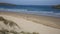 Surfers walking towards camera Crantock bay and beach North Cornwall England UK