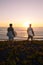 Surfers watching the waves at sunset