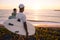 Surfers watching the waves at sunset