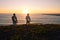 Surfers watching the waves at sunset