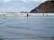 Surfers in Wetsuits Surfing