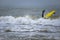 Surfing in the Baltic sea. Man struggling in the waves, trying to surf. Cold and windy autumn. Fun activity and sport.