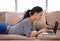 Surfing in the best seat in the house. a young woman sitting in her living room using a laptop.