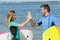 Surfing couple giving each other high five