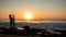 Surfing lifestyle. Silhouette of surfer girl with surfboard on the beach. Golden sunset time. Bali, Indonesia