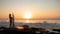 Surfing lifestyle. Silhouette of surfer girl with surfboard on the beach. Golden sunset time. Bali, Indonesia