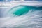 Surfing ocean wave with turquoise water and blue sky