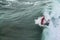 Surfing. Riding waves. An anidentified surfer catches a wave.