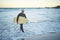 Surfing, surfboard and senior man on beach for water sports while walking on adventure after riding sea waves on a