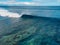 Surfing wave in tropical ocean at Mauritius. Aerial view of One eye