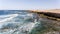 Surfing waves, rocky beach, volcanic cliffs, Canary Islands coast