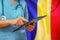 Surgeon or doctor using a digital tablet on the background of the Moldova flag