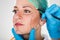 Surgeon Drawing Perforation Lines On Woman`s Face