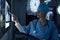 Surgeon examining x-ray while writing on clipboard in operating room of hospital