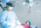 Surgeon operating surgery using VR goggles at hospital operation theater showing with copy space - concept of modern