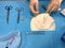 Surgeon`s hands suturing on a sterile table.