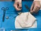 Surgeon`s hands suturing on a sterile table.