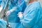 Surgeon's hands in white latex gloves in the operating room.