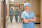 Surgeon Standing Arms Crossed In Hospital Corridor