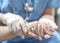 Surgeon, surgical doctor, anesthetist or anesthesiologist holding patient`s hand for health care trust and support in professional