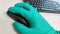 Surgeon surgical doctor on hygiene protective disinfection green glove clicking mouse, Researching and analysing in hospital labor