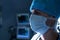 Surgeon with surgical mask looking away in operating room of hospital