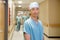 Surgeon With Team Walking In Hospital Corridor
