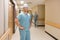 Surgeon With Team Walking At Hospital Corridor