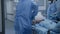 Surgeons transport elderly patient to hospital ward down clinic corridor