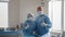 Surgery, medicine and people concept - group of surgeons in operating room at hospital showing thumbs up. Group of