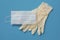 Surgical gloves and mask on a blue background