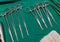 Surgical instruments and tools including needle, gauze, scissor arranged on a table for a surgery in an operation room