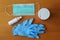 Surgical mask, latex gloves, hand sanitizer and antiseptic wet wipes on wooden background. Coronavirus protection