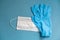 Surgical white mask and latex gloves for protection on a blue background