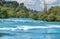 Surging water of Waikato river rushing between bush clad edges