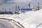 Surgut, Russia, 02.06.2019: snow-covered sign on the road indicates the direction to Nefteyugansk and GRES. The inscription on the