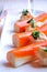 Surimi sticks with sauce on a white plate closeup