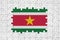 Suriname flag in frame of white puzzle pieces with missing central part